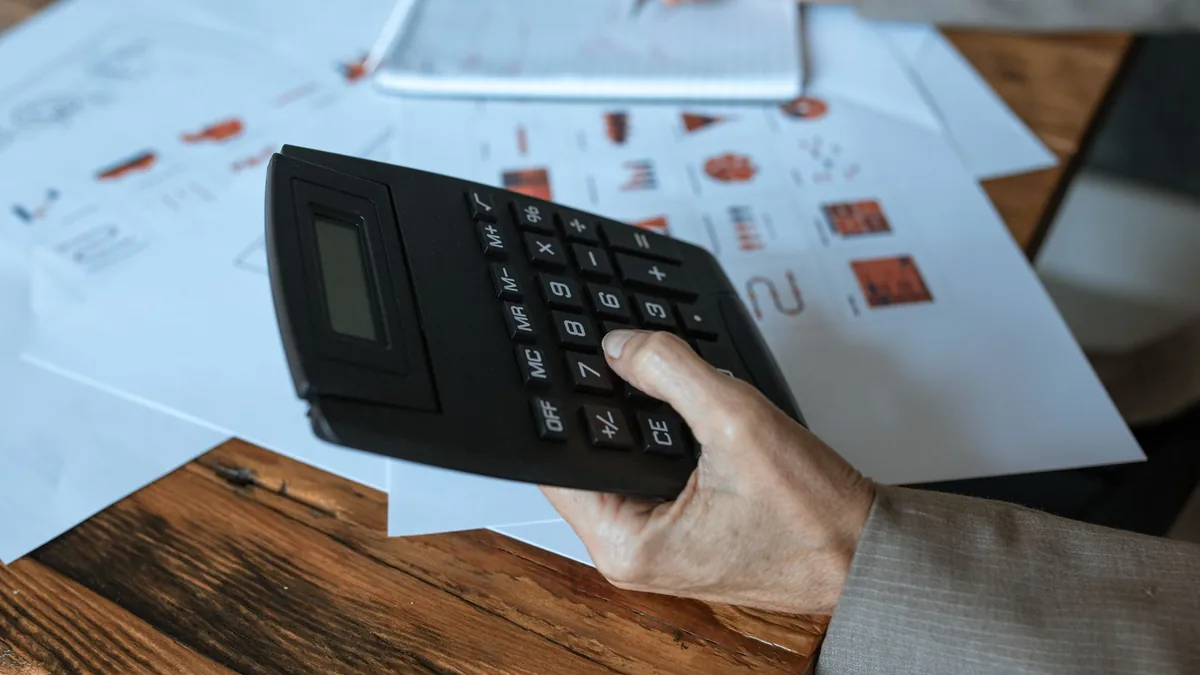 A small business owner reviewing a budget at a desk