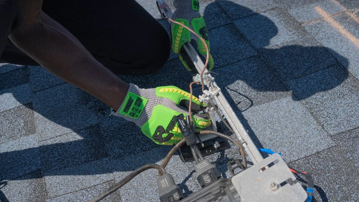 An electrician working on an electrical panel